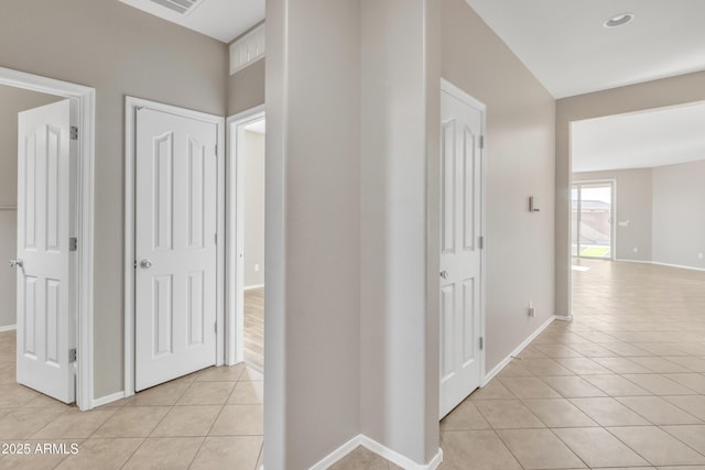 corridor with light tile patterned flooring