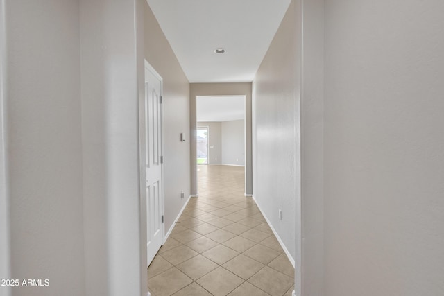 hall with light tile patterned floors