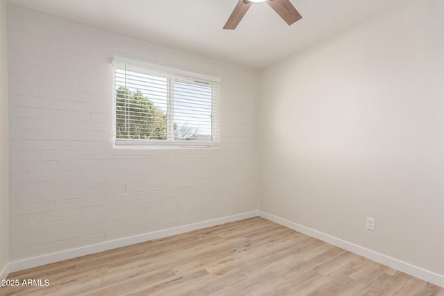 unfurnished room with a ceiling fan, light wood-style flooring, and baseboards