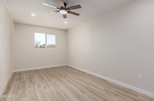 unfurnished room with light wood-type flooring, baseboards, and recessed lighting