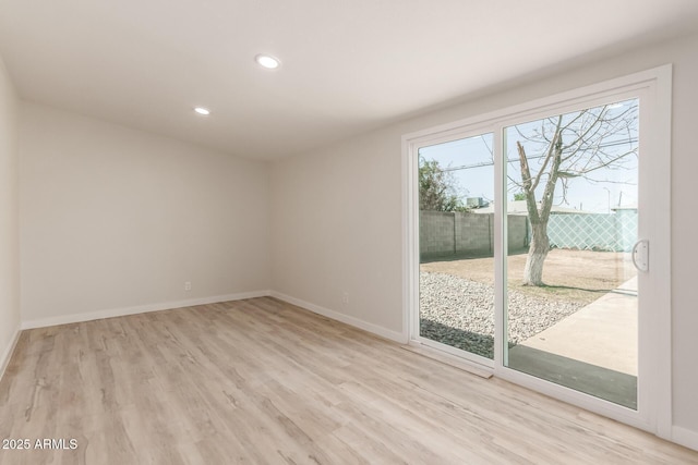 empty room with baseboards, recessed lighting, and light wood-style floors