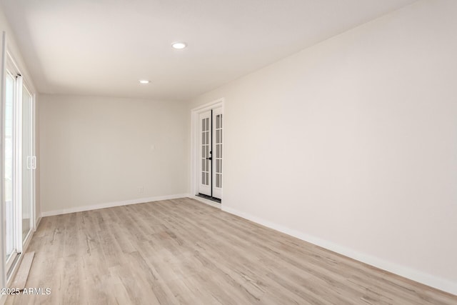 spare room featuring light wood-style flooring, baseboards, and recessed lighting