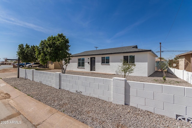 ranch-style house with fence private yard and brick siding