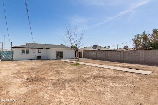 back of house featuring central air condition unit and fence private yard