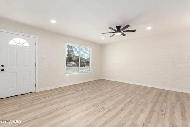 entrance foyer with recessed lighting, light wood-style floors, a ceiling fan, brick wall, and baseboards