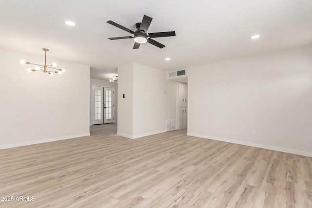 empty room featuring french doors, visible vents, baseboards, and light wood finished floors