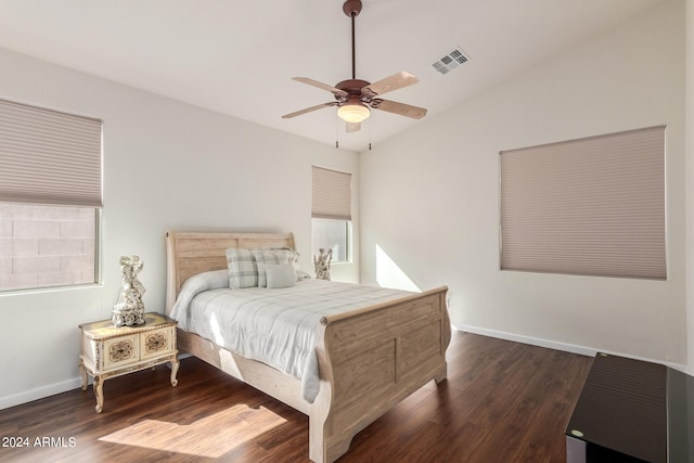 bedroom with ceiling fan, vaulted ceiling, and dark hardwood / wood-style flooring