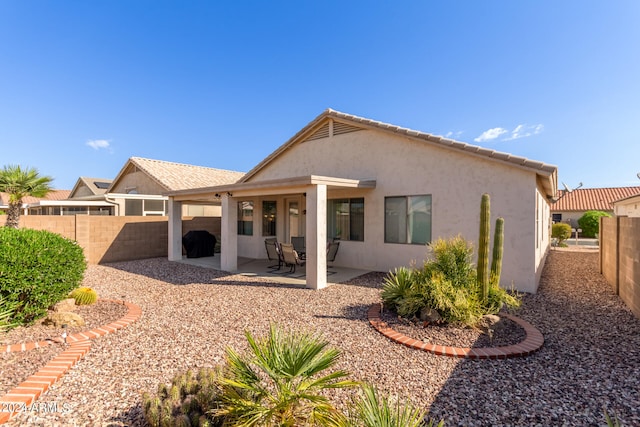 back of property featuring a patio