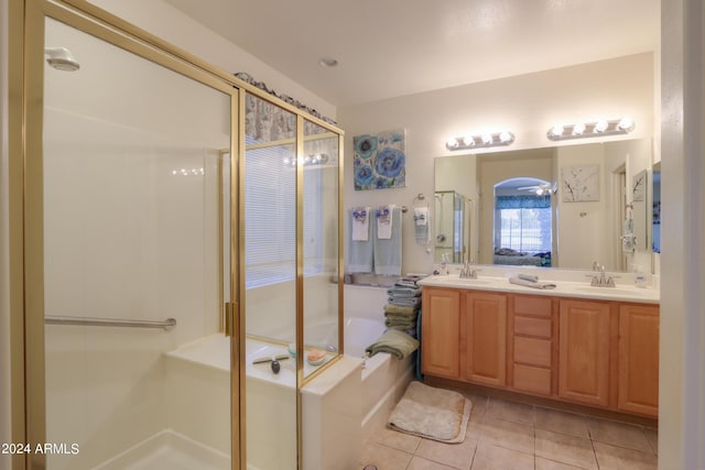 bathroom featuring a sink, a garden tub, a stall shower, and tile patterned flooring