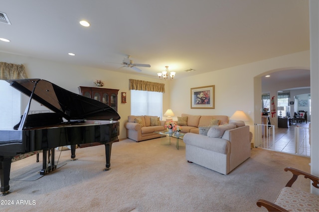 carpeted living area featuring arched walkways, visible vents, recessed lighting, and a wealth of natural light