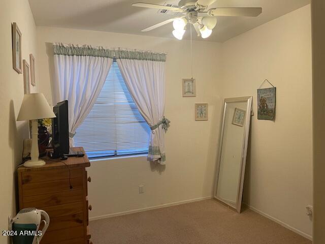 unfurnished bedroom with baseboards, carpet floors, and ceiling fan