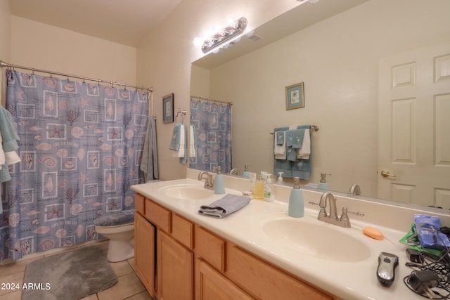 bathroom featuring a sink, toilet, double vanity, and tile patterned flooring