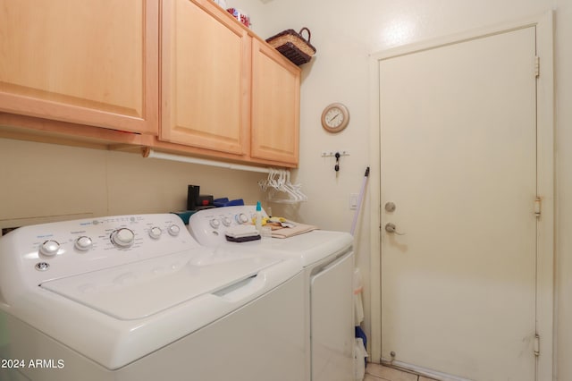 clothes washing area with cabinet space and washing machine and clothes dryer