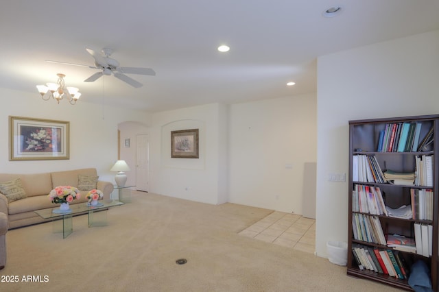 carpeted living area with recessed lighting and ceiling fan with notable chandelier