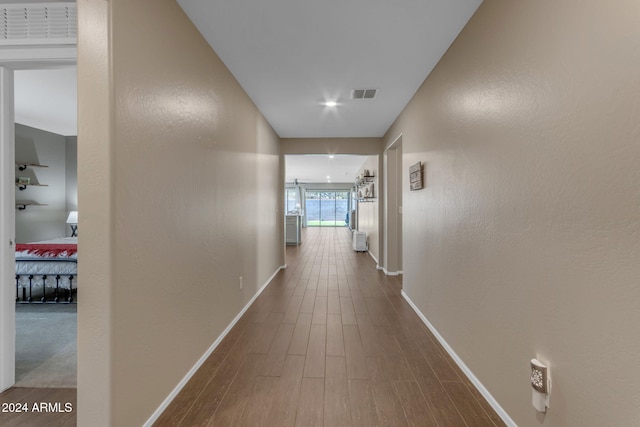 hall with wood-type flooring