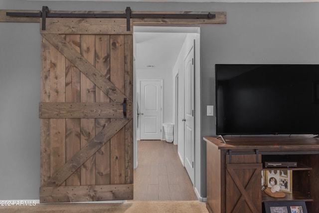 interior space featuring a barn door and hardwood / wood-style flooring