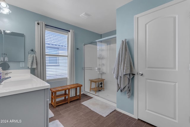 bathroom with vanity, walk in shower, and hardwood / wood-style floors