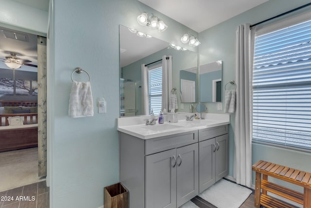 bathroom with vanity, an enclosed shower, and ceiling fan