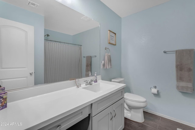 bathroom with toilet, hardwood / wood-style flooring, vanity, and a shower with curtain