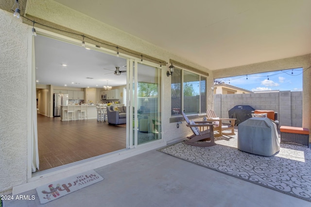 view of patio with ceiling fan and a grill