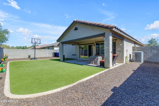 back of property with a patio area, central AC, a yard, and ceiling fan