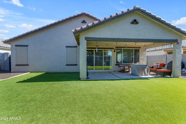 rear view of house featuring a yard, ceiling fan, and a patio area