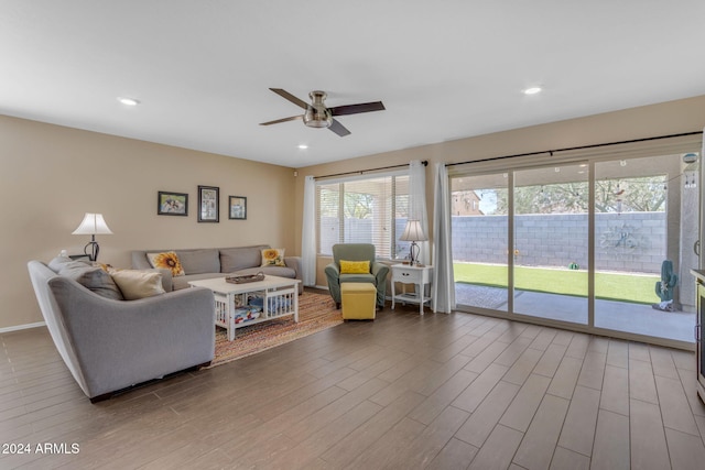 living room featuring ceiling fan and hardwood / wood-style floors