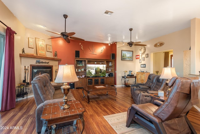 living room with ceiling fan and wood-type flooring