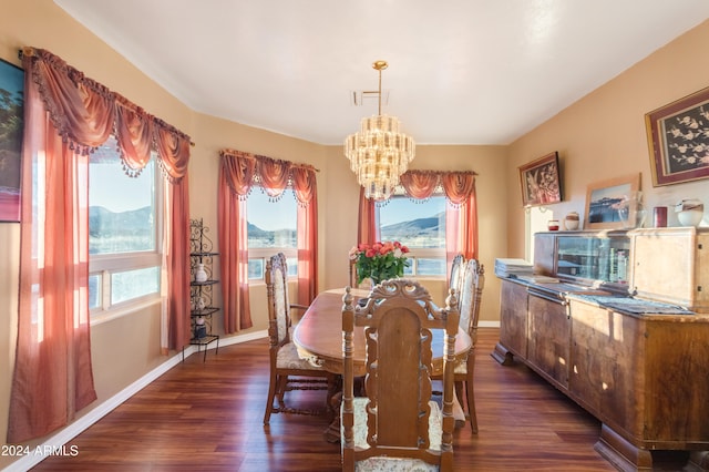 dining area with a chandelier, a mountain view, and dark wood-type flooring