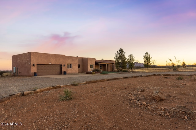 pueblo-style home featuring a garage