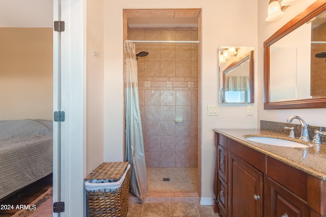 bathroom with tile patterned floors, vanity, and walk in shower