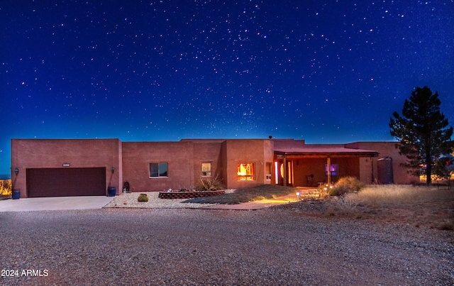 pueblo-style house featuring a garage