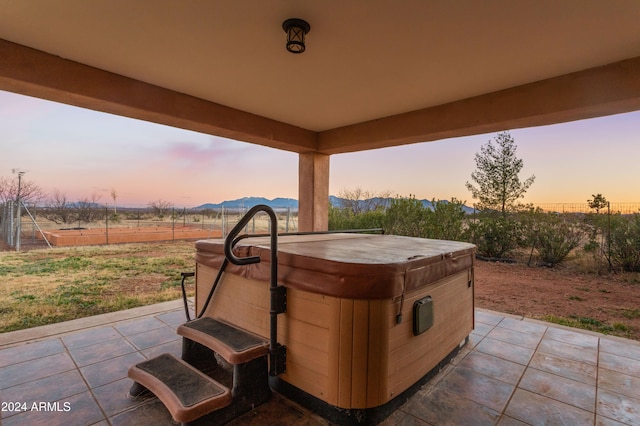 patio terrace at dusk with a hot tub