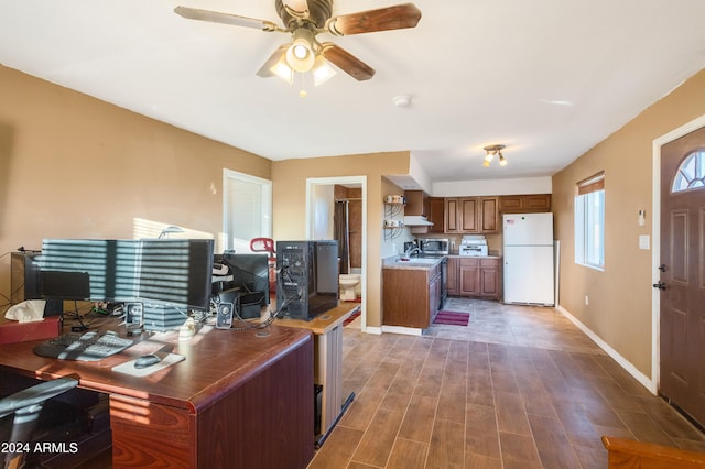 office area with ceiling fan, sink, and dark hardwood / wood-style floors