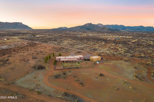 aerial view at dusk featuring a mountain view