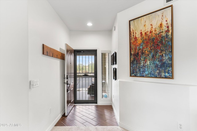 foyer featuring baseboards