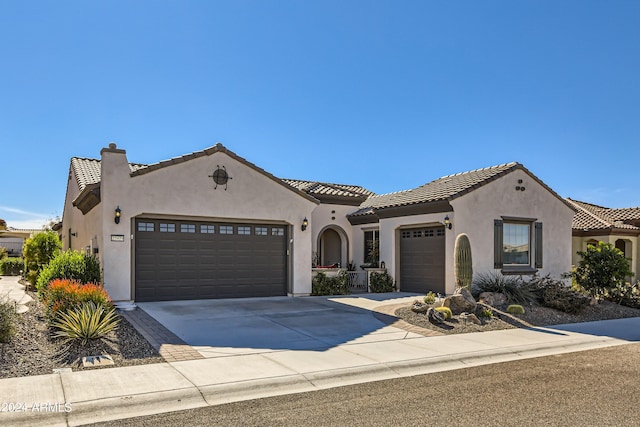 25979 W Taro Dr, Buckeye, AZ 85396 - mediterranean / spanish house with an attached garage, stucco siding, a tiled roof, and driveway