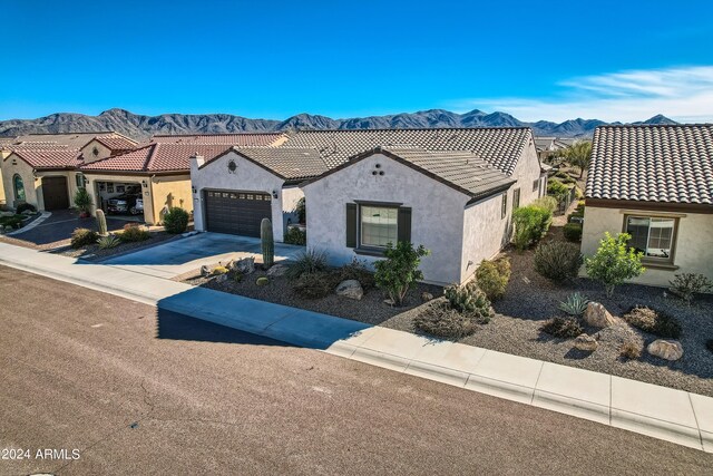 25979 W Taro Dr, Buckeye, AZ 85396 - mediterranean / spanish-style home with stucco siding, a garage, a mountain view, and driveway