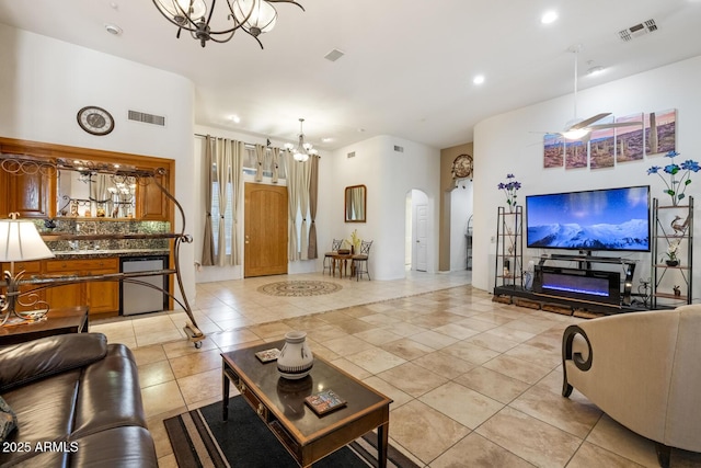 8167 E Sand Flower Dr, Scottsdale, AZ 85266 - living room with a chandelier, arched walkways, light tile patterned floors, and recessed lighting