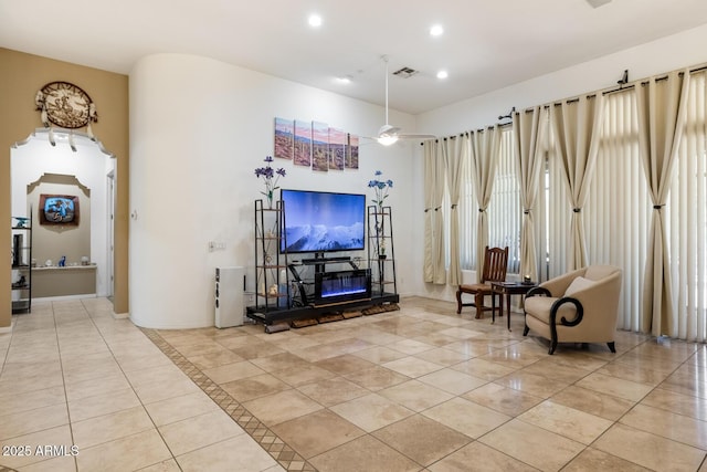 8167 E Sand Flower Dr, Scottsdale, AZ 85266 - living room featuring light tile patterned floors, recessed lighting, a ceiling fan, a towering ceiling, and baseboards