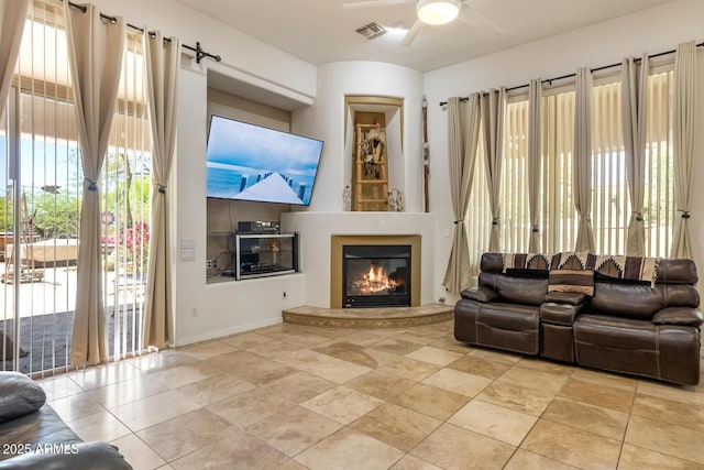 8167 E Sand Flower Dr, Scottsdale, AZ 85266 - living room featuring ceiling fan, plenty of natural light, and a glass covered fireplace