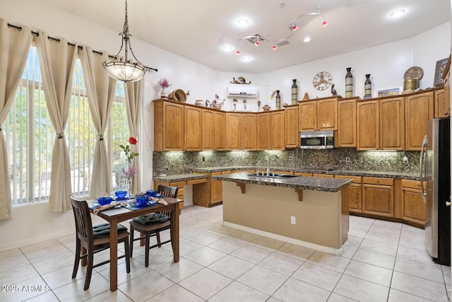 8167 E Sand Flower Dr, Scottsdale, AZ 85266 - kitchen featuring appliances with stainless steel finishes, a sink, brown cabinets, backsplash, and recessed lighting