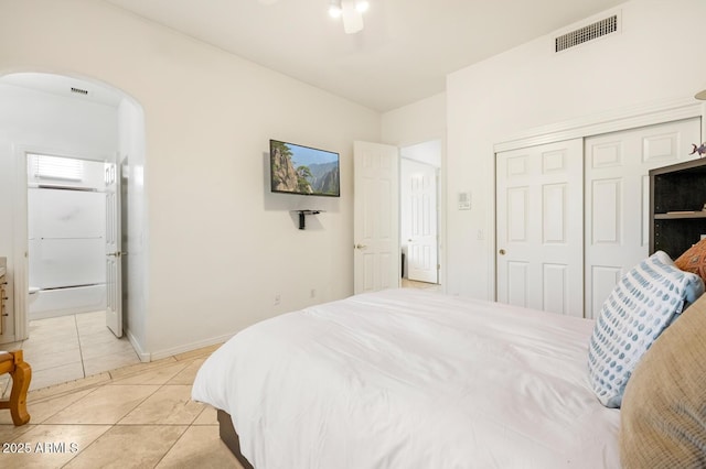8167 E Sand Flower Dr, Scottsdale, AZ 85266 - bedroom with arched walkways, a closet, light tile patterned floors, ensuite bathroom, and a ceiling fan