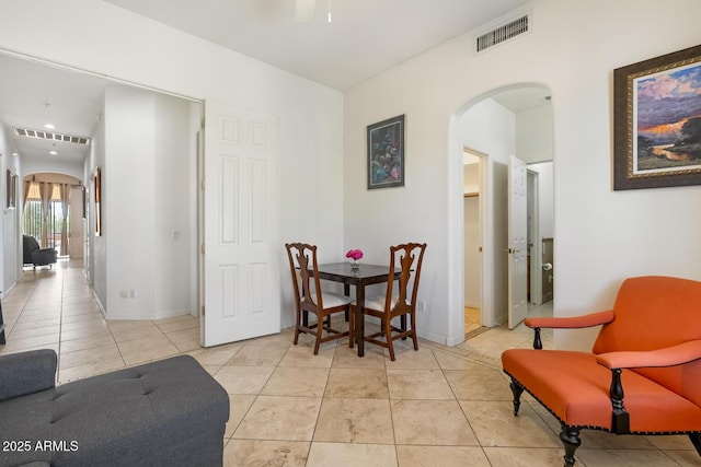 8167 E Sand Flower Dr, Scottsdale, AZ 85266 - dining space featuring arched walkways, light tile patterned flooring, and baseboards