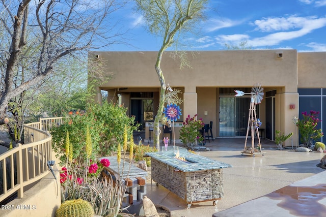 8167 E Sand Flower Dr, Scottsdale, AZ 85266 - back of property featuring a fire pit, a patio, and stucco siding