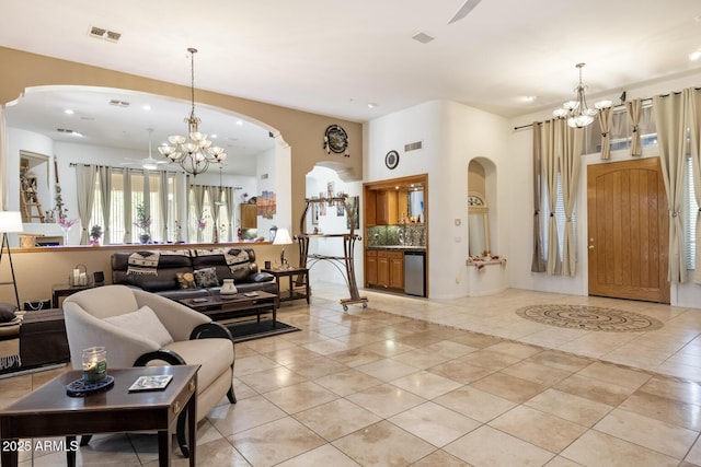 8167 E Sand Flower Dr, Scottsdale, AZ 85266 - living area featuring a chandelier, arched walkways, light tile patterned floors, and recessed lighting