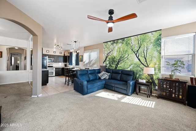 carpeted living room with ceiling fan