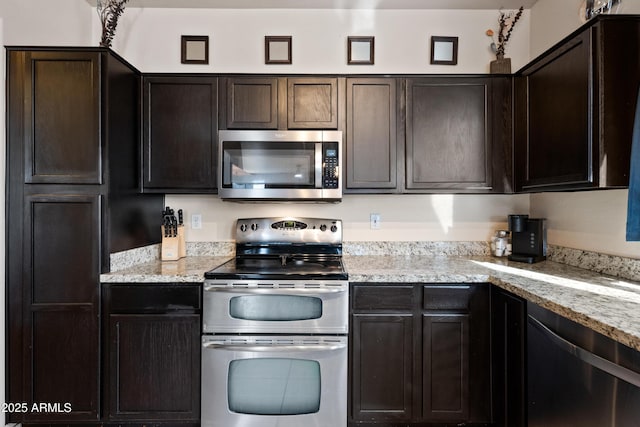 kitchen featuring light stone countertops, dark brown cabinetry, and stainless steel appliances