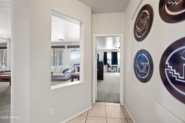 hallway featuring light carpet