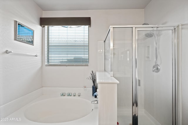 bathroom featuring separate shower and tub and a healthy amount of sunlight